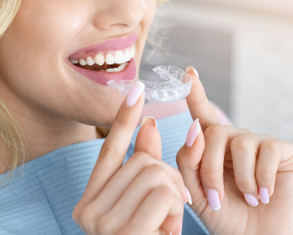 Woman fitting a Invisalign Clear Aligner