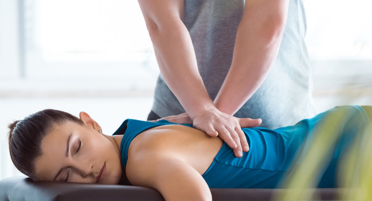 Female patient receiving a back adjustment