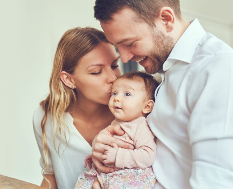 Mom and dad holding their baby