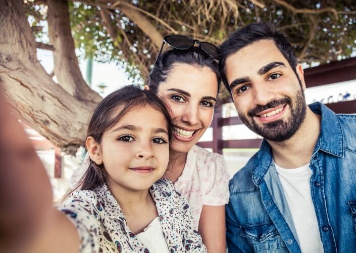 Family of three posing for a selfie