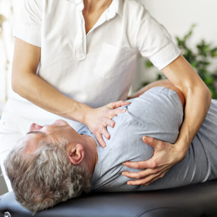Chiropractic shoulder adjustment for male patient