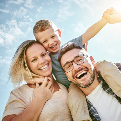 Smiling family of three
