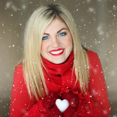 woman in red coat with snow heart
