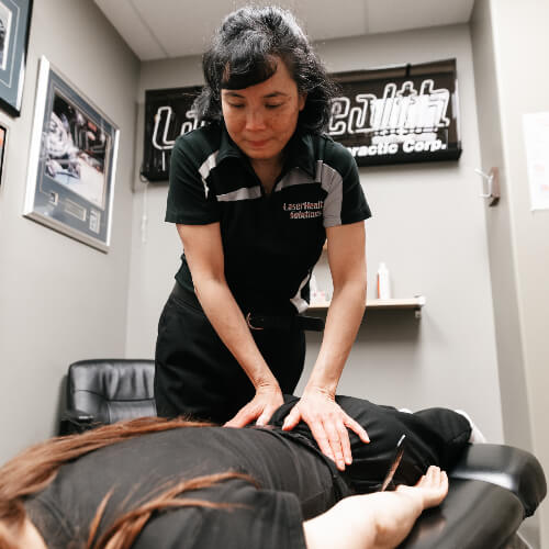 Female patient receiving a chiropractic adjustment