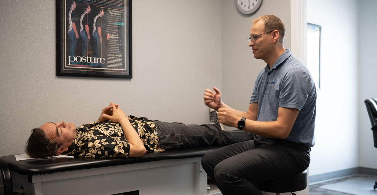 Dr. Aaron talking to patient on table