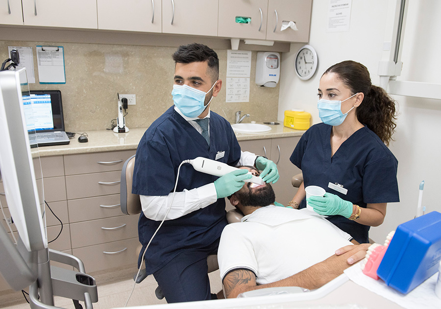 Doctors working with a patient in dental chair