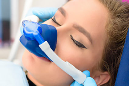 Woman wearing dental sedation mask