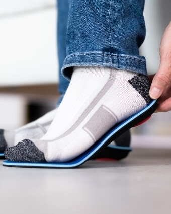 Man fitting orthotics