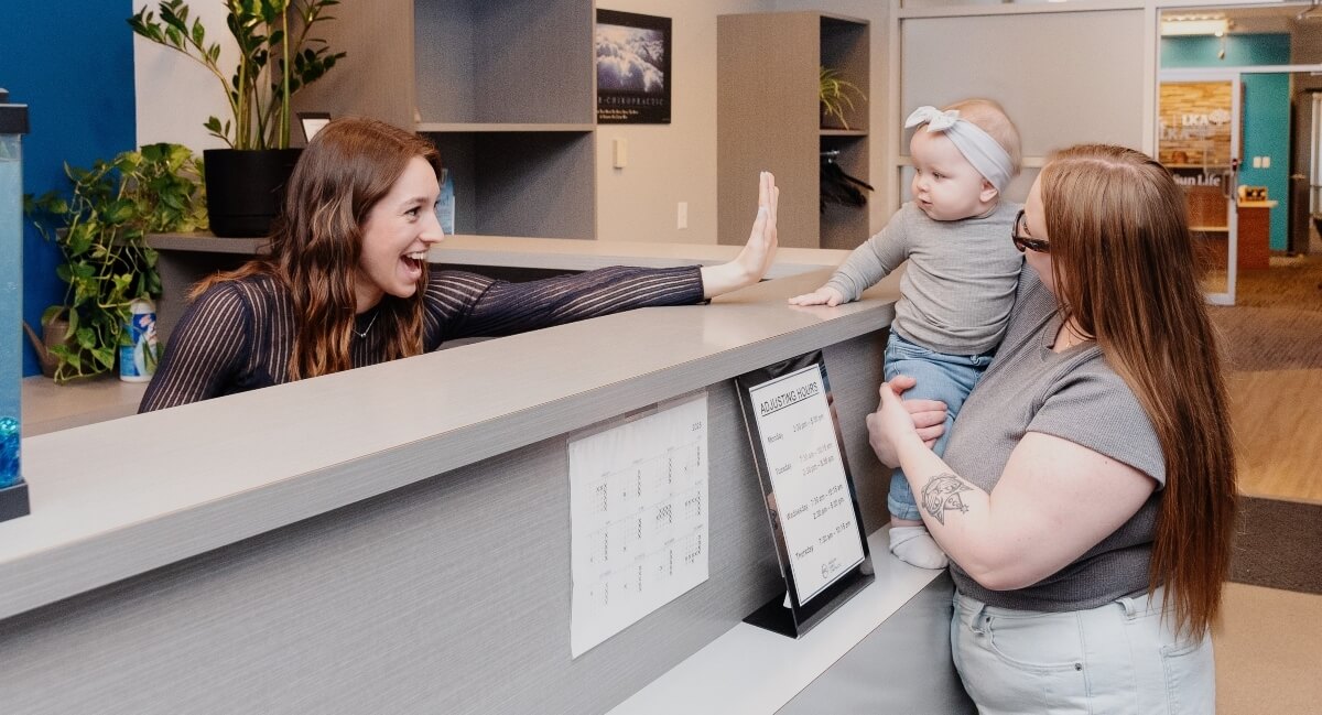 Mom and baby greeted at Parascak Family Chiropractic reception