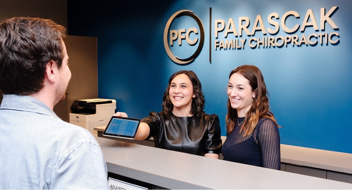 Parascak Family Chiropractic staff greeting patient