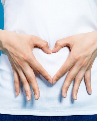 Heart shape with hands over tummy