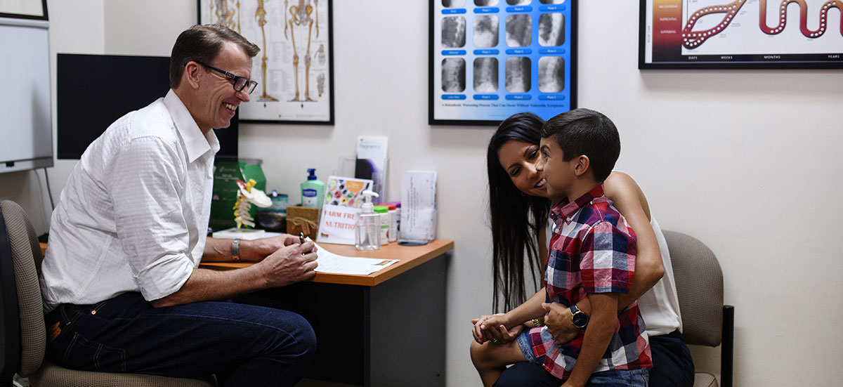 Doctor consulting with mom and child