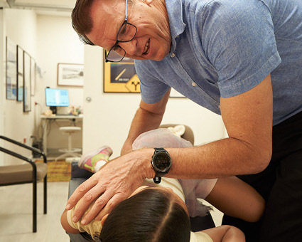 Dr Peterson with child patient at Cactus Chiropractic Lifestyle Centre