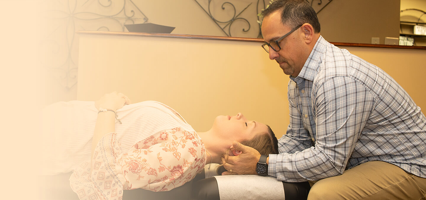 Dr. Jason Cerutti adjusting patint's neck