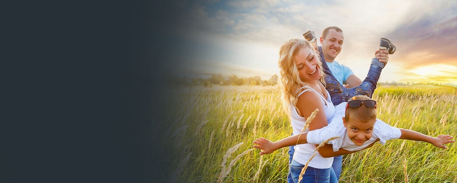 smiling family playing outdoors