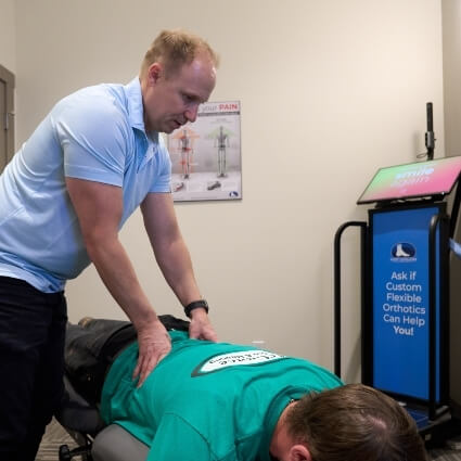Dr Chris adjusting patients back