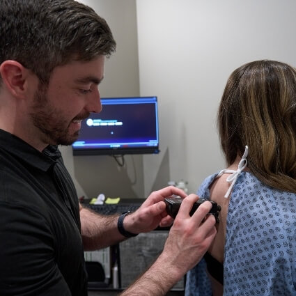 Dr Cody scanning patients back