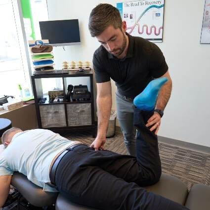 Dr Cody examining patients leg