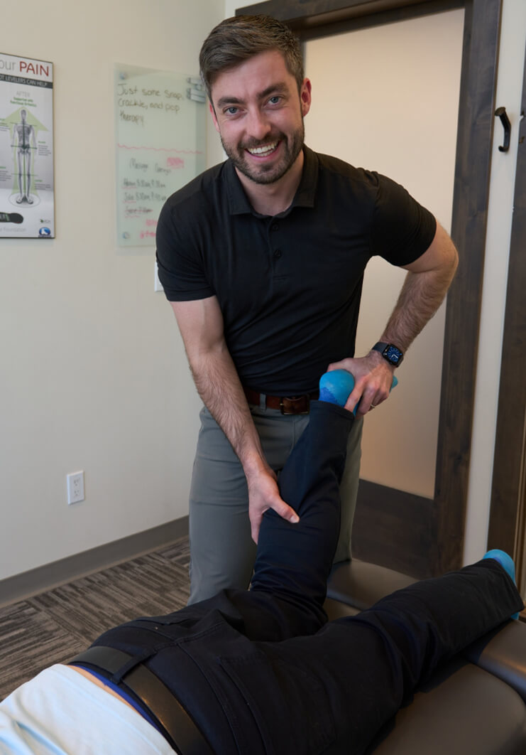 Dr Cody adjusting patients leg