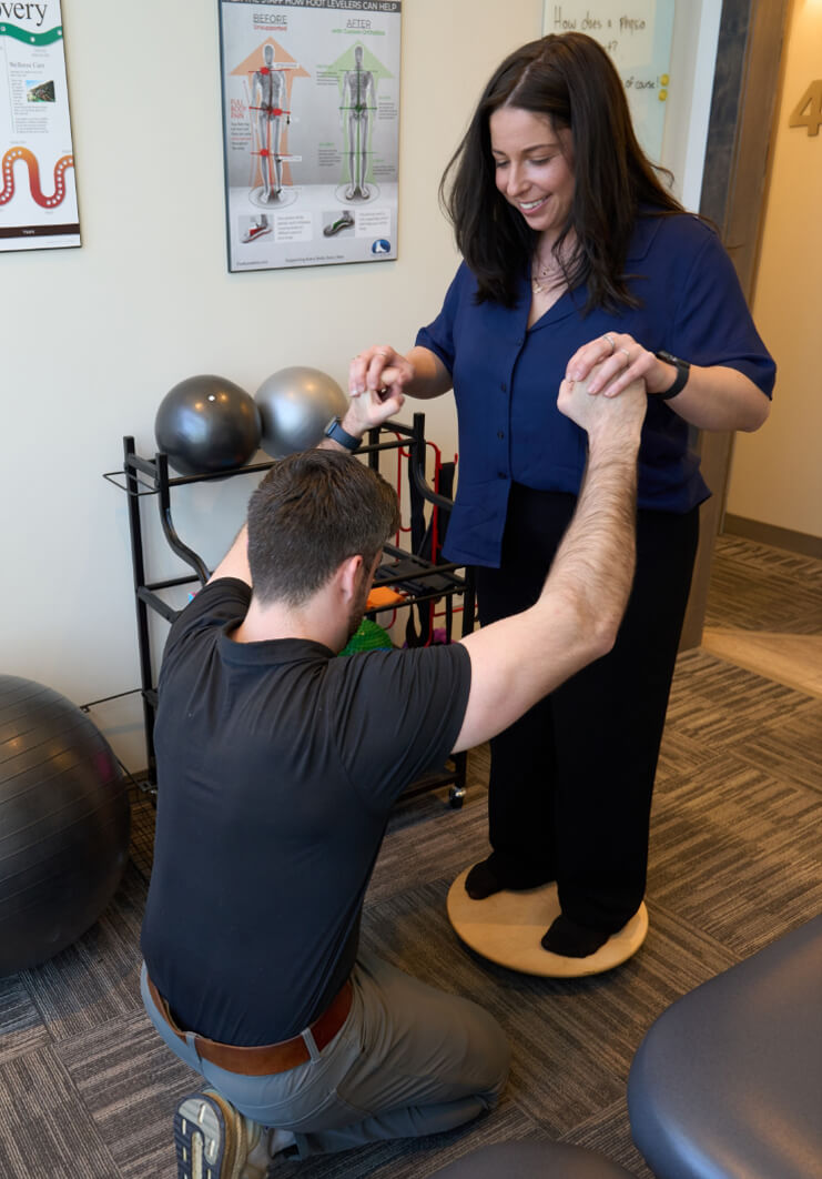 Dr Cody working with patient on balance tool