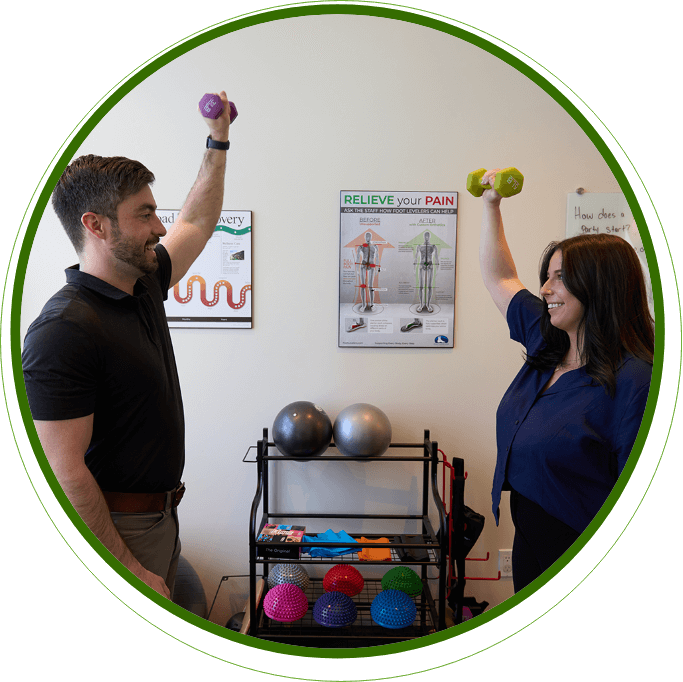 Okotoks chiropractor Dr Cody lifting weights with a patient