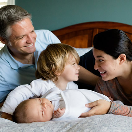 Family on bed with baby