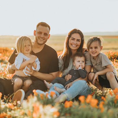 family smiling sitting on grass outdoor