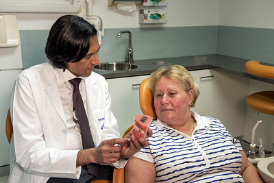 Dentist consulting with patient