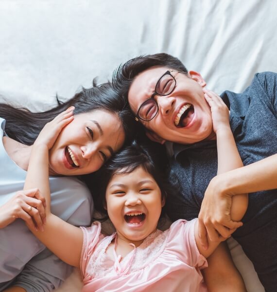 Laughing family of three