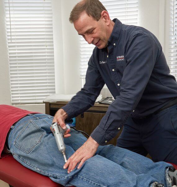 Chiropractor adjusting patient