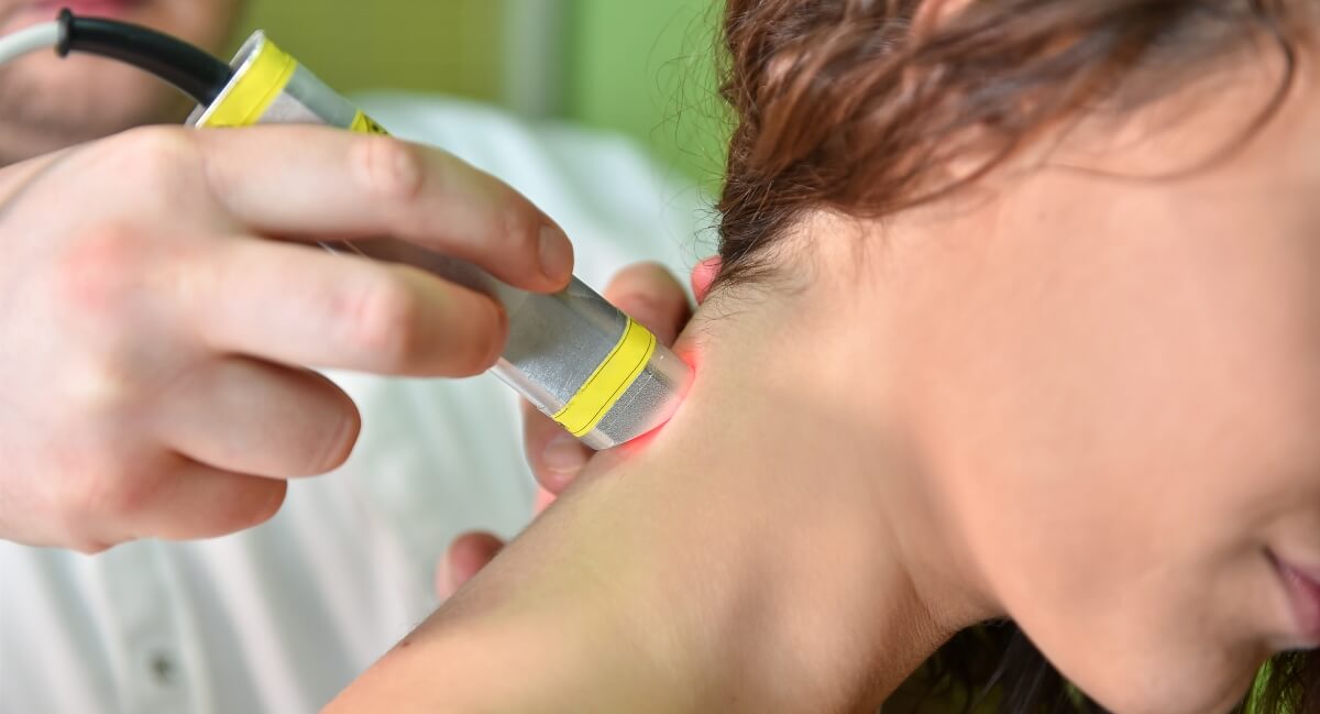 Female patient's neck treated with Laser Therapy