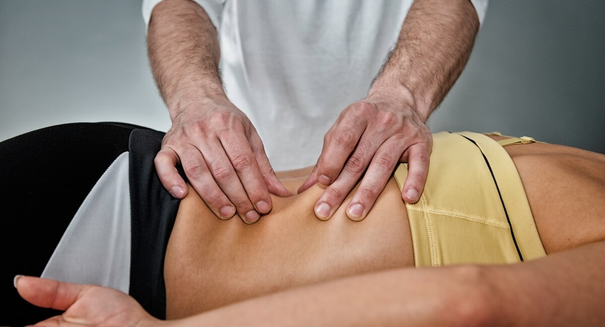 Chiropractor adjusting patient's back