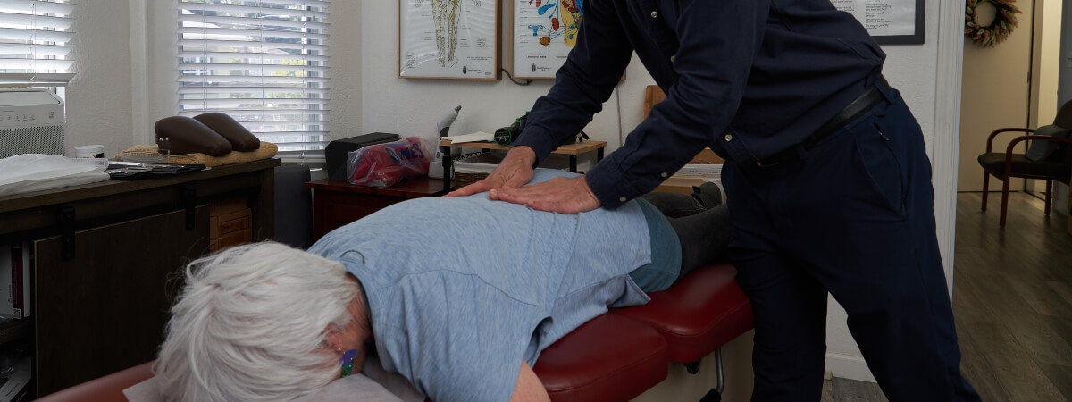 Oakland chiropractor adjusting patient's back