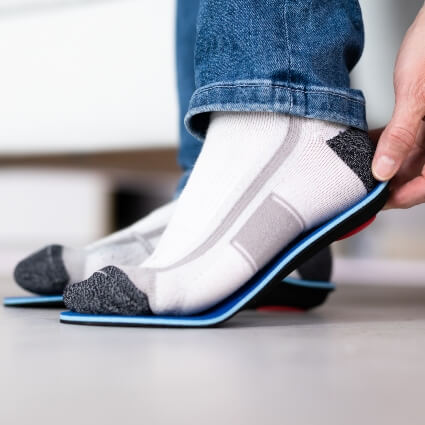 Man fitting orthotics