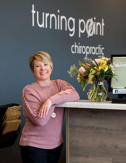 Dr. Brooke Block standing by front desk