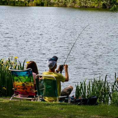 people fishing on a river