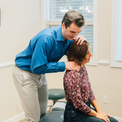 Williamsburg Chiropractor Dr. Panick adjusting woman's neck