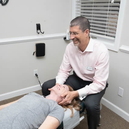 Dr. Shaye adjusting a patient's neck