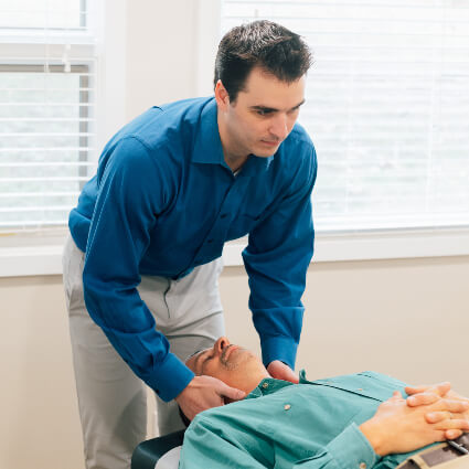 Williamsburg Chiropractor Dr. Panick adjust patient on table