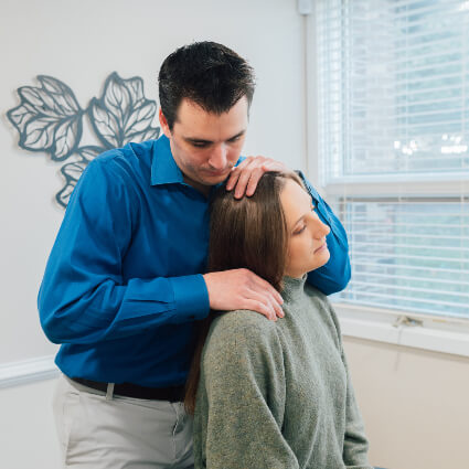 Williamsburg Chiropractor Dr. Panick adjusting woman's neck