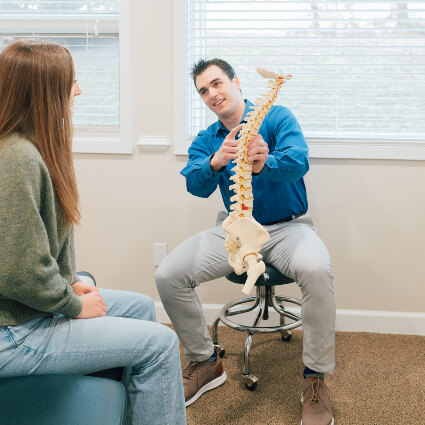 Performance Chiropractic Dr. Panick holding spine model