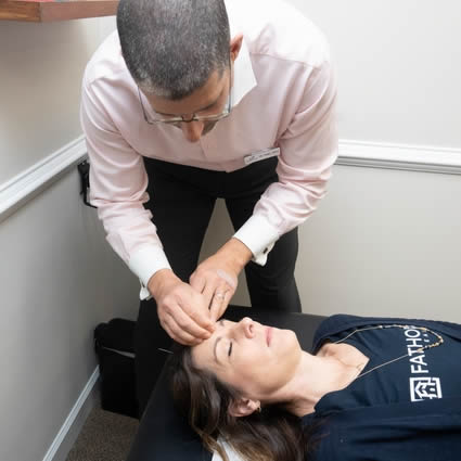 Dr. Shaye performing acupuncture