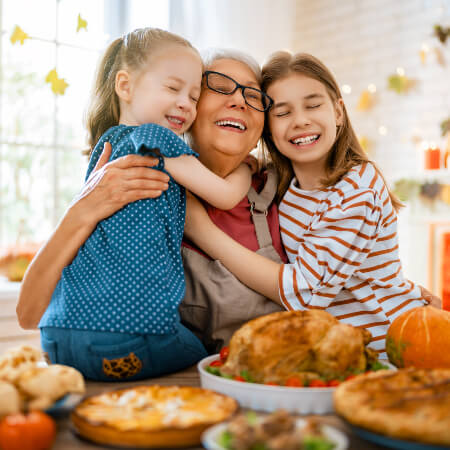 grandma-hugging-granddaughters-sq