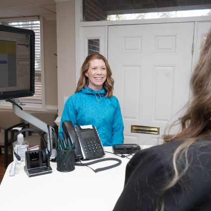 Patient smiling at receptionist