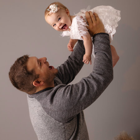 Morris chiropractor holding a baby in the air