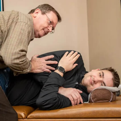 Dr. Pavel Bence adjusting patient