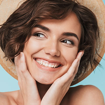 Woman smiling hands on face