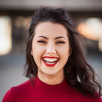 woman smiling with bright red lipstick
