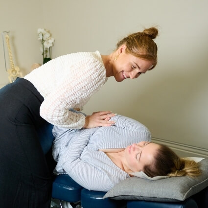 Dr Kaitlyn adjusting patients back