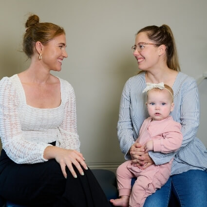 Dr Kaitlyn talking to patient with child